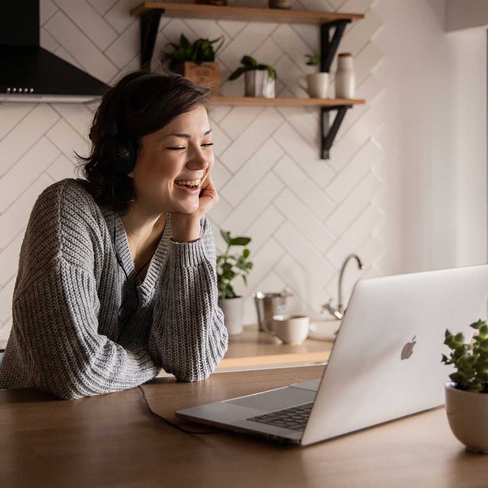 Woman working on computer laughing