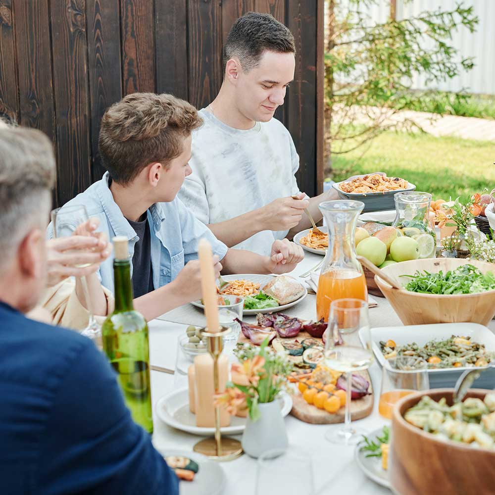 Men eating healthy at a picnic table